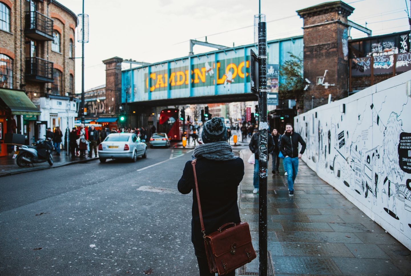 A person (assumed to be a tour guide) walking near Camden Lock